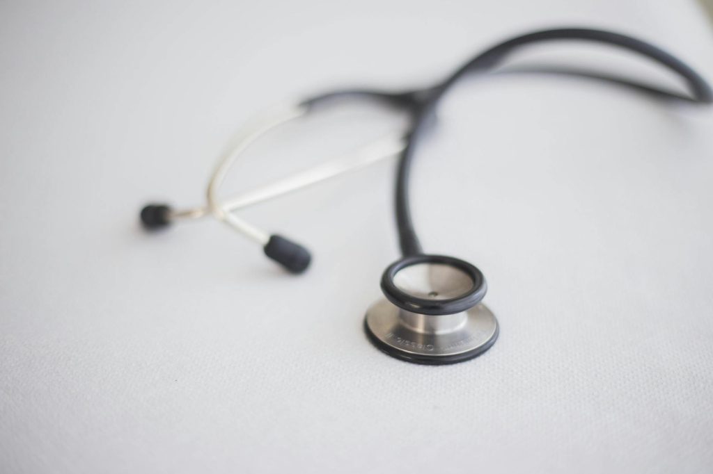 close up of a stethoscope lying on a white surface