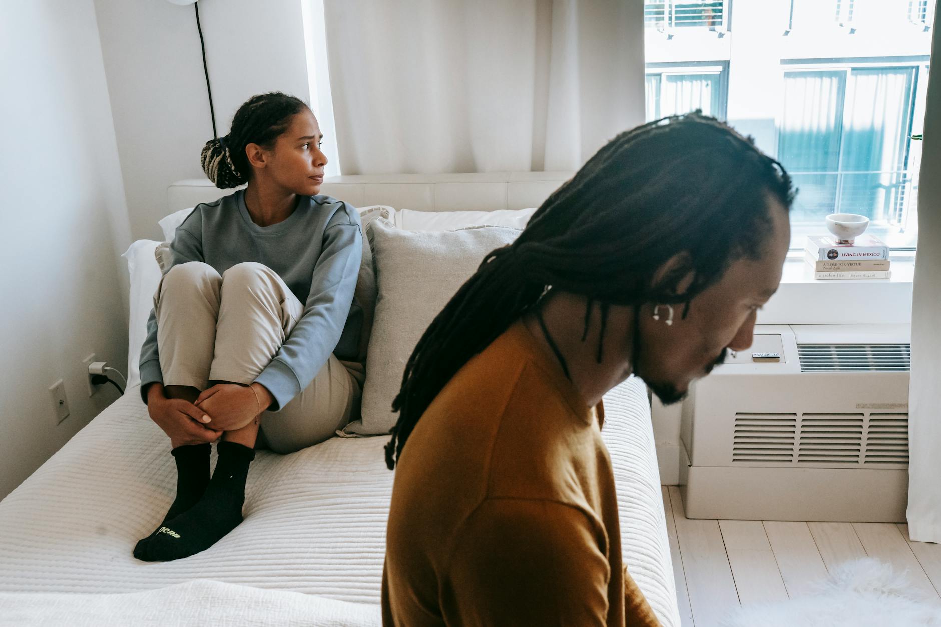 black couple spending time on bed at home